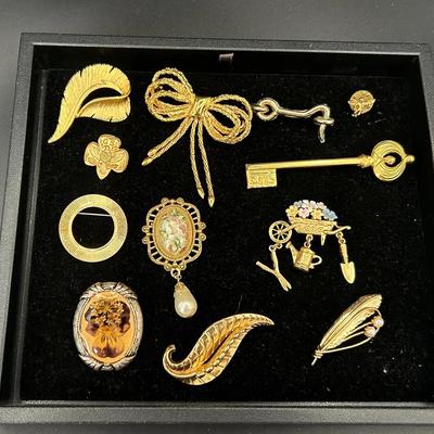 Twelve Gold Toned Broaches Featuring Pearl Feather Broach