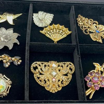 collection of assorted vintage and costume jewelry pins
