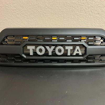 Lot 324: Aftermarket Toyota Front Grille with LED Marker Lights