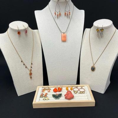 Various Orange Toned Earrings And Necklaces