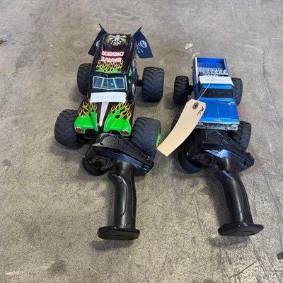 4524 • (2) monster truck rc model cars with remote controllers
