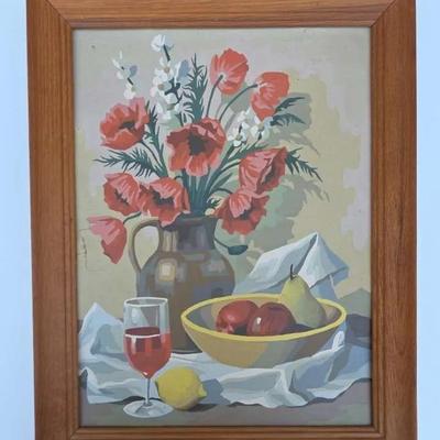 This is a vintage paint-by-number still life painting featuring flowers, fruit, and a pitcher. 
