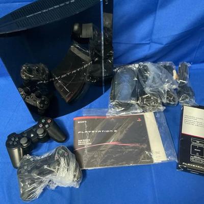 Sony Playstation 3 with Controllers, Cords, Booklets, & Memory Card Adaptor