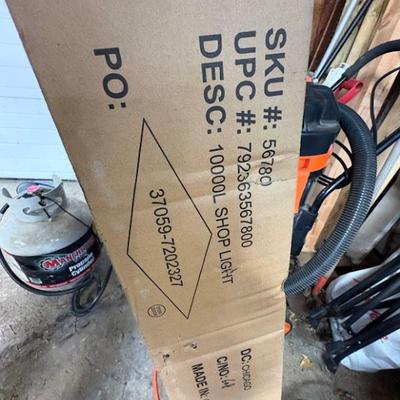 shop light, likely the Braun 10,000 Lumen 4 ft. Linkable Diamond Plate LED Hanging Shop Light