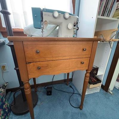 a vintage Singer 327 sewing machine housed in a wooden cabinet