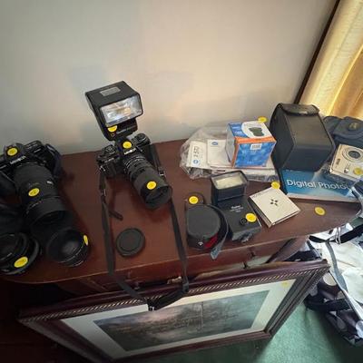 Minolta X-700 35mm film SLR camera with a lens and a Starblitz 3600DFM flash attached, Minolta Maxxum 7000 35mm film camera with an...