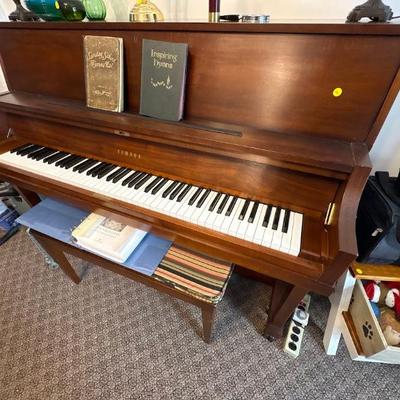Yamaha P22 upright piano, a model known for its durability and use in schools and studios. Walnut finish.