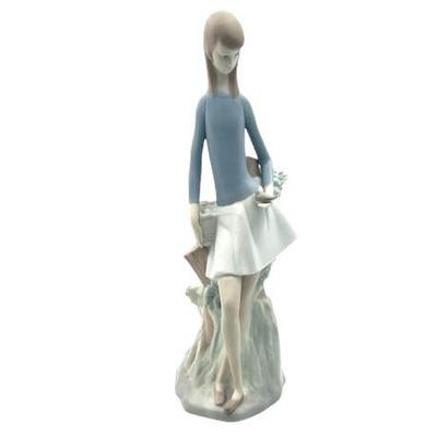 Sale Photo Thumbnail #88: Lot 148   
Lladro Nao, "Girl With Bird In Hand" Porcelain Figurine, 14