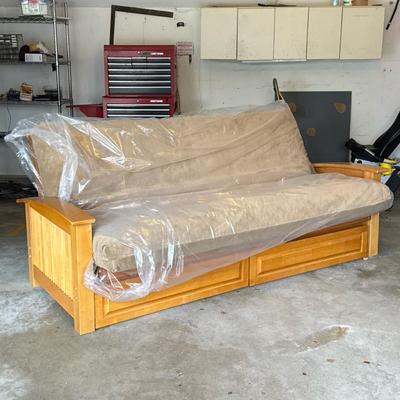 FOLDING FUTON SOFA IN EXCELLENT CONDITION | Having a faux suede single mattress/cushion on a wooden frame with slatted sides over two...