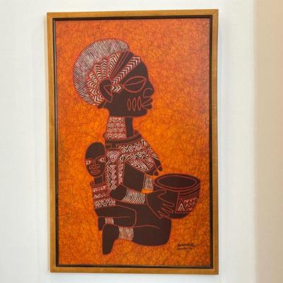 African Batik Textile Painting | Batik textile artwork depicting a stylized mother and child on an orange ground, with characteristic...