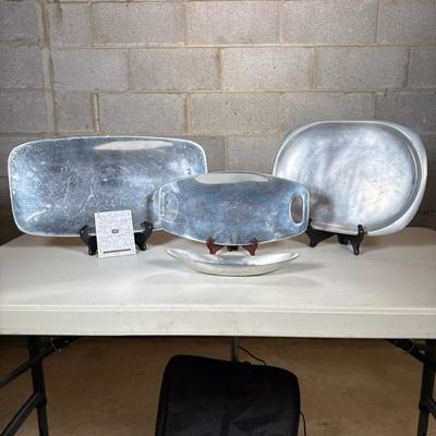 (4pc) Nambe Serving Platters And Pewter Dish | Three oblong platters, one with handles. In addition, a small pewter oblong serving dish,...
