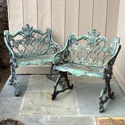 PAIR FANCY CHARLESTON STYLE CAST IRON GARDEN CHAIRS | A pair of ornate cast iron garden benches with scrolling forms, lattice backs, and...