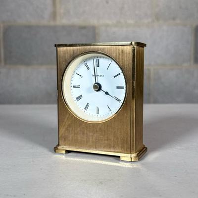 Tiffany & Co. Small Brass Desk Clock | With Roman numeral markers; quartz movement Dimensions: h. 3.75 x w. 3 in

