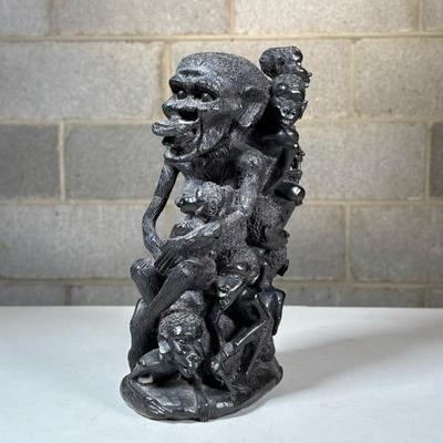 African Carved Hardwood Figural Group | Dark carved wood with many figures, highly textured, having a dominant central figure with...