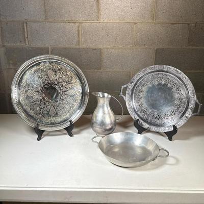 (4pc) Misc. Silver Toned Serving Dishes, Pitcher | Group of mixed metal serving pieces including: one pitcher marked “India,” one handled...