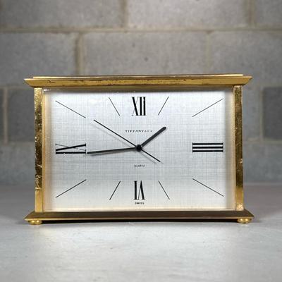 Tiffany & Co. Brass Desk Clock | Swiss made quartz clock with Roman numeral markers Dimensions: h. 4.5 x w. 7 x d. 2.75 in
