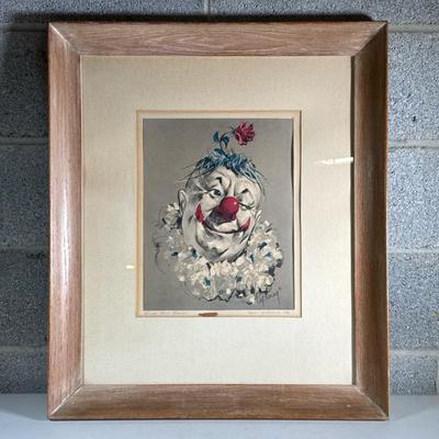 (2pc) Framed And Signed Clown Prints | One happy and one sad clown in light wooded frames. Dimensions: h. 27.5 x w. 24 x d. 1 in
