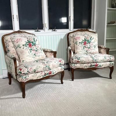Pair French Provincial-Style Bergere Chairs | Armchairs with carved wood frames with floral upholstery and matching down cushions, over...