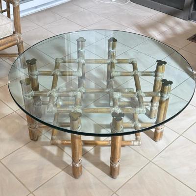 McGUIRE RATTAN, RAWHIDE & GLASS LOW TABLE, ORGANIC MID CENTURY | Low table designed as a round glass top resting on a woven wood /...