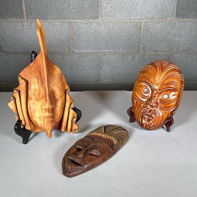(3pc) Leather & Wood Masks | Including a formed leather mask and two African carved masks, one with abalone eyes. - h. 12.25 x w. 8...