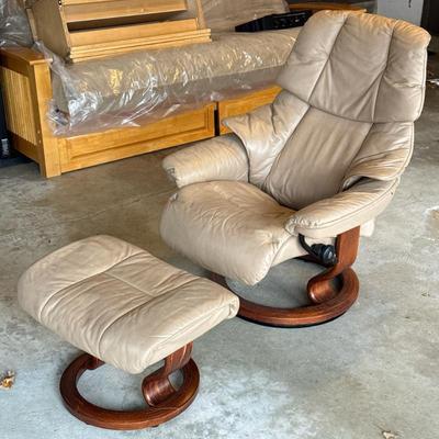 EKORNES STRESSLESS LOUNGER & OTTOMAN | Light colored leather chair with circular wood footing and matching footstool. Same footing...