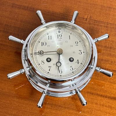 SALEM SHIP’S BELL CLOCK | Yacht wheel form ship’s bell clock in a chrome case with hinged bezel and glass cover, having an 8-day...
