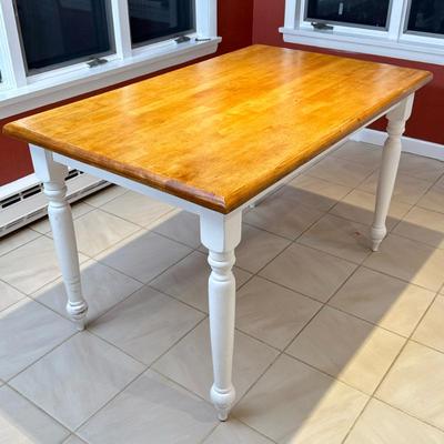 Farmhouse-Style Kitchen Table | A small kitchen dining table having a light wood top over carved white legs and support, of rectangular...