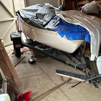 SMALL 9.5ft SAILBOAT AND TRAILER | Wood interior with blue paint on a fiberglass hull
