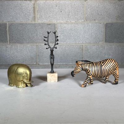 (3pc) Animal Figures | Including a Turkish deer on a stone pedestal, a brass elephant, and a painted wood zebra (l. 6.75 in.) Dimensions:...