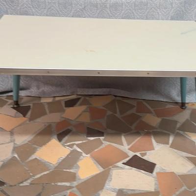 Vintage MCM Formica-top table with blue tapered legs. 