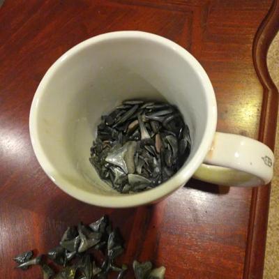Mug Of Shark Teeth And Bowl Of Shells