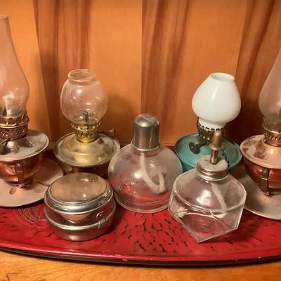 A collection of miniature oil lamps