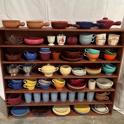 A shelf full of colorful pottery