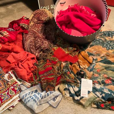 Scarves a mix of sizes shapes mostly in red