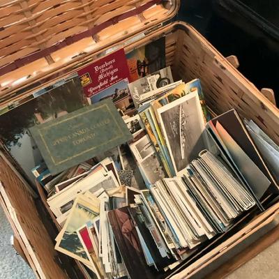 Picnic basket full of vintage post cards