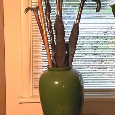 Ceramic vase with canes umbrellas & a golf club