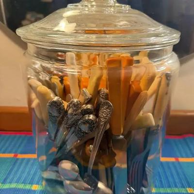 Collection of flatware in a lidded jar
