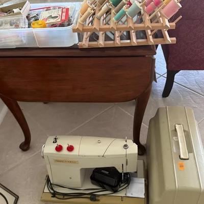 Sewing and Craft Lot with Vintage Sewing Machine, Thread Spool Racks, Thread, Buttons, and Notions