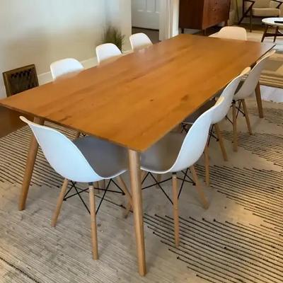 Wood dining table with eames style white chairs