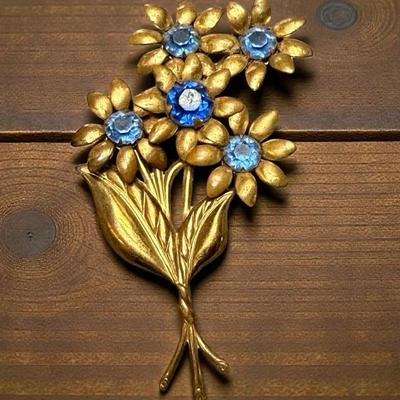 Vintage gold tone bouquet brooch with blue stones