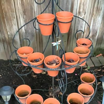 Wrought iron multi tier plant stand with terracotta pots