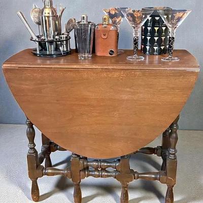 Drop leaf gate leg table with assorted bar ware