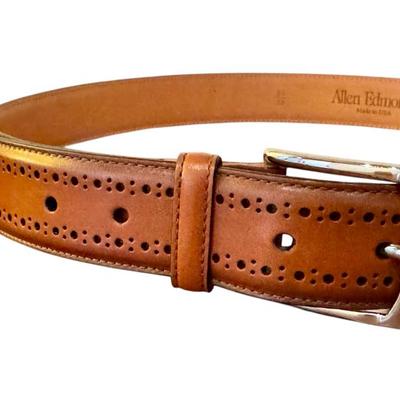 Classic Allen Edmonds men's leather belt in cognac brown, made in the USA. Features elegant brogued detailing and a polished...
