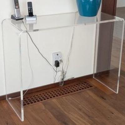 Lucite Console Table 

Modern Lucite console table with clean, minimalist lines. The table measures 38 inches wide by 15 inches deep and...