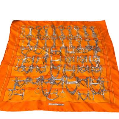 Elegant Hermes Paris 'Mors et Filets' scarf crafted in 100% silk. Features an orange background with intricate horse bit and...