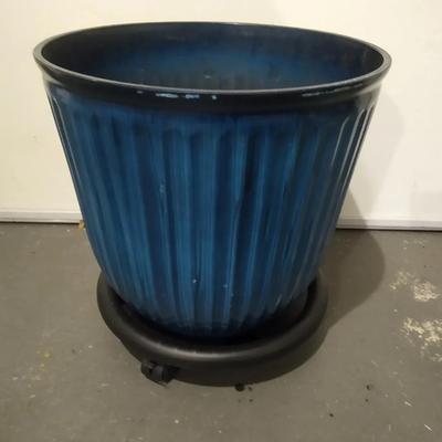 Blue plastic planter pot with rolling stand