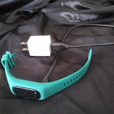 Garmin vívosmart fitness tracker in a teal colored band
