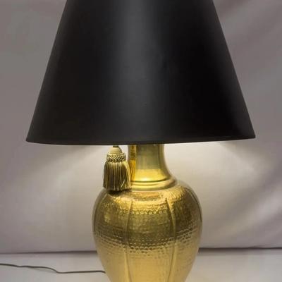 hammered gold table lamp with a black shade