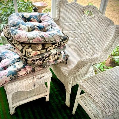 This photo features mainly the beautiful White wicker loveseat, coffee table, 2-tier larger side tables, and available cushions
