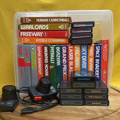 Collection of 30 Atari 2600 video game cartridges and controllers (no console)